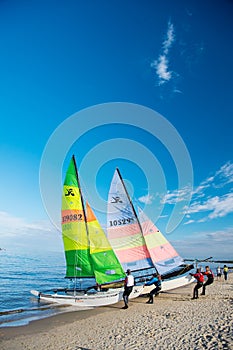 Windsurfer or man sportsman surfs and sails on board