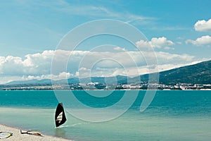 Windsurfer rides to shore along waves of Gelendzhik Bay Vacation Surfing Concept