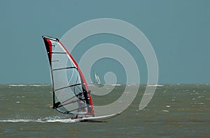 Windsurfer and sailboat