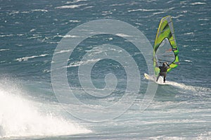 Windsurfer sailing in the sea.