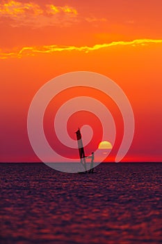 Windsurfer silhouette against sun