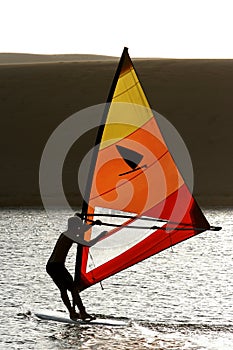 Windsurfer Silhouetted on Lake