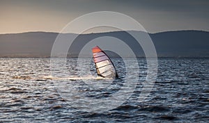 Windsurfer Surfing The Wind On Waves at Sunset