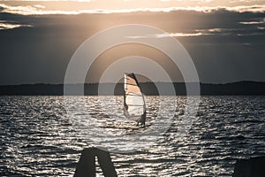 Windsurfer Surfing The Wind On Waves at Sunset