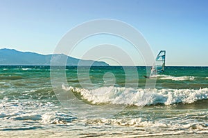 Windsurfers in the sea on Crete on sunset. Windsurfing in Heraklion