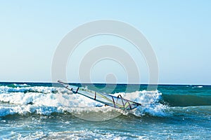 Windsurfers in the sea on Crete on sunset. Windsurfing in Heraklion