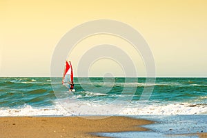 Windsurfers in the sea on Crete on sunset. Windsurfing in Heraklion. Greece