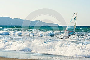 Windsurfers in the sea on Crete on sunset. Windsurfing in Heraklion. Greece