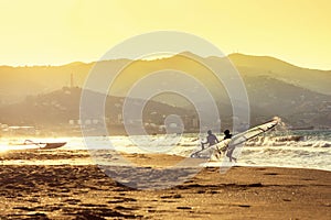 Windsurfers in the sea on Crete on sunset. Windsurfing in Heraklion. Greece