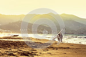 Windsurfers in the sea on Crete on sunset. Windsurfing in Heraklion. Greece