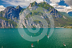 Windsurfers surfing on a Garda lake