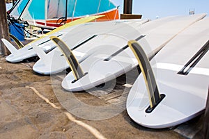 Windsurfing boards storage on a beach watersports facility. Stocked boards photo