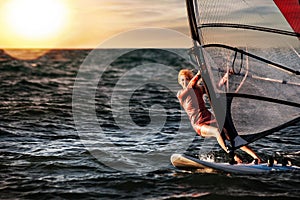 Windsurfing, Fun in the ocean, Extreme Sport. Woman lifestyle