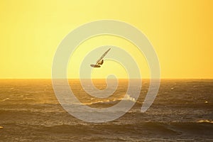 Windsurfing high jump at sunset