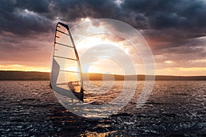 Windsurfing on a lake at sunset