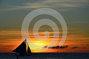 Windsurfing silhouette against sunset