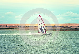 Windsurfing Sport sailing water active leisure Windsurfer on lake summer day