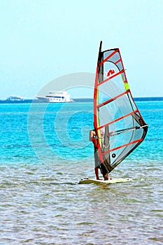 Windsurfing. Surfer exercising in calm sea or ocean