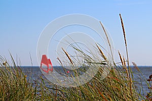 Windsurfspot Ringkobing Fjord with two windsurfers in bokeh Hvide Sande, Denmark