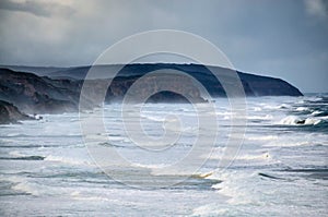 Windswept rough coastline with breaking waves and white water