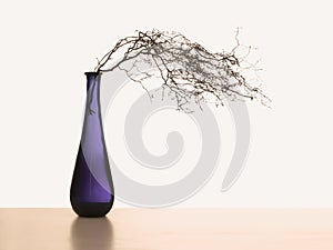 Windswept still life with copyspace. Twigs and purple, violet vase with white behind.