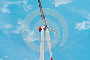 Windtech Maintenance Worker Inspecting a Renewable Energy Wind Turbine By Visual Evaluation of the Rotor Blades