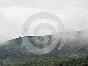 Windtowers visible through fog on Vermont hilltop photo