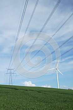 A windturbine close to a electric pylon photo