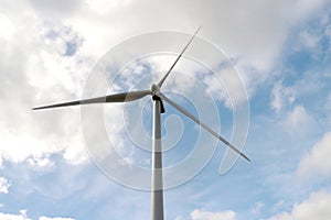 Windturbine high in the blue sky at the europoort harbor