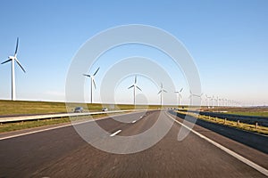 Windturbines along a countryroad photo