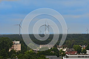 Windturbines on the horizon of a town