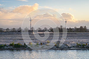 Windturbines with sunlit clouds in the background