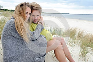 Windy autumn days relaxing on coast - sand dune, beach, beautiful couple