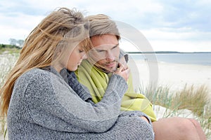 Windy autumn days relaxing on coast - sand dune, beach, beautiful couple