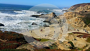 Windy blustery day at Bodega bay beach. People still enjoying the day.