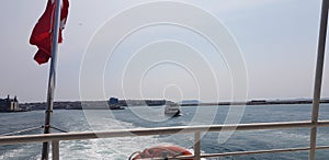 a windy day, the foam marks left by the boat and the waving Turkish flag, kadikoy