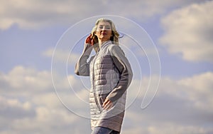 Windy day. Girl jacket cloudy sky background. Woman fashion model outdoors. Woman enjoying cool weather. Freshness of
