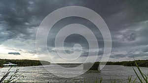 Windy day with storm clouds above the lake