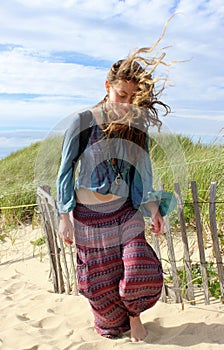 Una adolescente en la playa en un día ventoso.