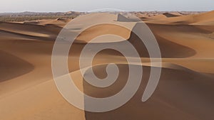 Windy desert sand dunes landscapes in the Sahara desert, Mhamid, Erg Chigaga, Morocco.