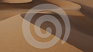 Windy desert sand dunes landscapes in the Sahara desert, Mhamid, Erg Chigaga, Morocco.