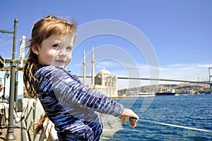 Windy hair, a little baby girl on the Pier when it blows hard