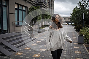 Windy weather, hairs close woman`s face, sad mood and cold weather. wind blowing hair.