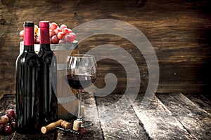 Wine background. A barrel with red wine and freshly grapes.
