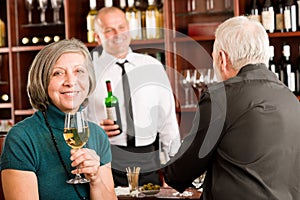 Wine bar senior couple barman discussing