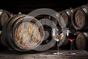 Wine barrel  and two wine glasses on the old wooden table
