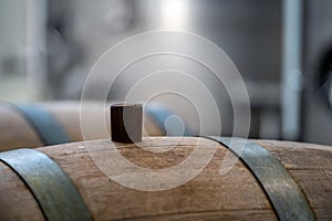 Wine barrel with wooden bung, closeup, selective focus