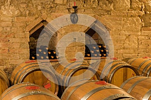 Wine barrels and bottles in a traditional cellar