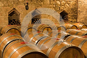 Wine barrels and bottles in a traditional cellar
