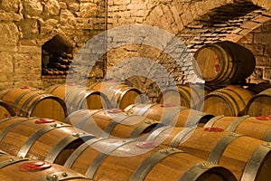 Wine barrels and bottles in a traditional cellar